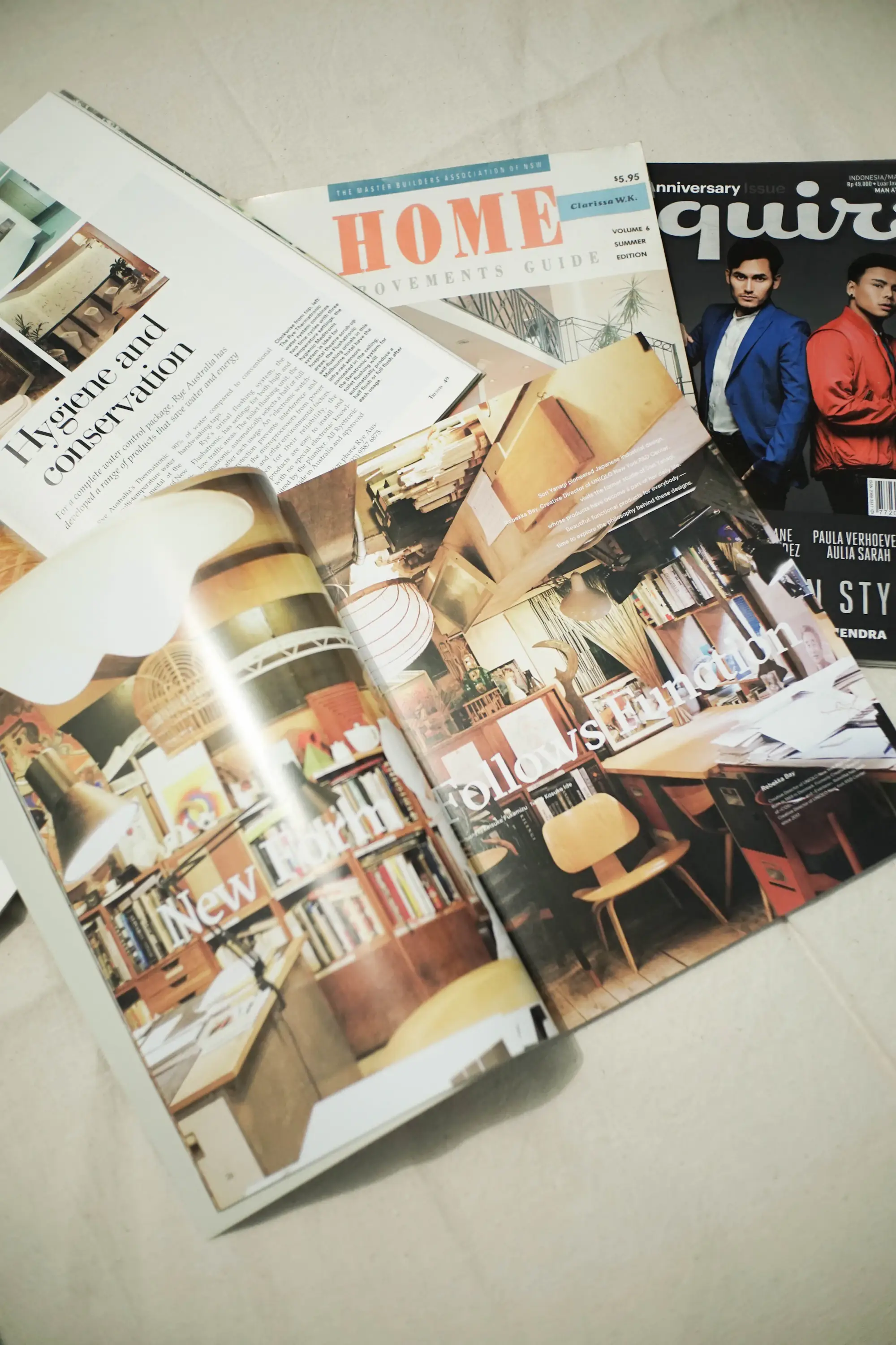 An open magazine spread with photographs and printed articles