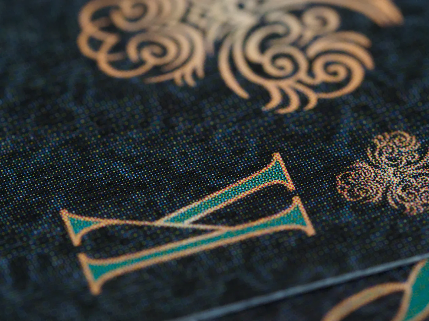 Close-up of a cloth-bound book cover with gold foil lettering and ornament
